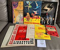All eight ephemera pieces arranged on sofa
