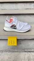 Side profile of both shoes showing upper, midsole, outsole, size tag 133 for reference