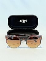 Front view of sunglasses with case open behind