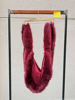 Faux fur stole hanging full length showing exterior fur and satin lining