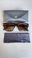 Front view of sunglasses with case and cloth