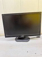 Front view of Philips 23-inch monitor showing black bezel and base