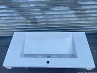 Top view of cultured marble sink top showing basin and faucet hole