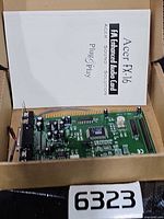 Sound card resting in box with manual behind it