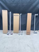 Full lot showing boxed towel bar and two chrome faucet handles