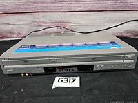 Front and top view of Sony SLV-D271P combo unit with attached power cord and RCA jacks visible