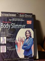 Front of sealed Angelina Body Slimmer retail packaging
