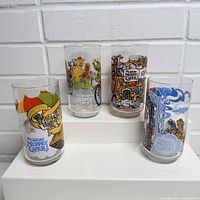 Set of four illustrated Muppet Caper glasses front view