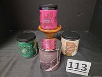 All four candles and wooden stand grouped