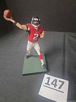 Front view of Matt Ryan action figure on base