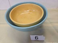Two nesting bowls, teal outer, yellow inner