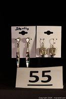 Both pairs of earrings front view on cards