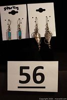 Both earring pairs on display cards; lot overview