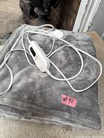 Folded gray electric blanket with controller on top
