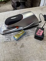 Stapler, adapter, and loose staples on table