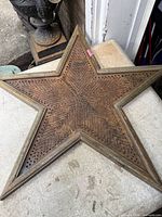 front view of five-point perforated steel star with wood frame