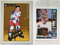 Front view of both oversized hockey cards: Bathgate in sleeve, Roy in wrapper