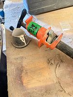Clamp head showing screw handle, orange cast iron body, size tag