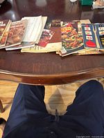 Two stacks of small cookbooks and pamphlets on table