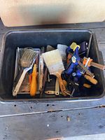 Overview of tub with brushes, clamps, scrapers