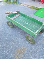 Top view of green wooden wagon on pavement