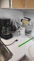 Overall view of coffee maker, iron, hand mixer, stand mixer with bowl