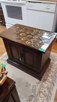 Front view of side table cabinet with trivets on top