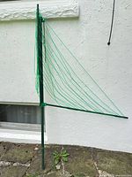 Full view of folded clothesline showing metal pole and lines
