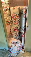Curtain panels, valance, bed skirt and fabric roll hanging and on floor