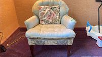 Front view of armchair showing upholstery and legs