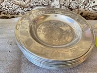 Stack of Wilton Armetale charger plates showing reflective alloy surface and overall condition