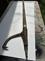 Full view of wooden handle and metal hook