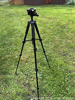 Tripod fully extended on lawn