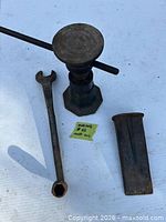 screw jack, wrench, wedge displayed on surface