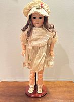 Full view of doll on stand