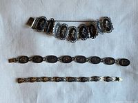 Three sterling niello bracelets laid flat