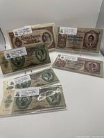 Front view showing all six Hungarian banknotes in sleeves