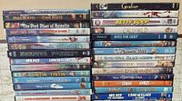 Two stacks of DVD and Blu-ray cases showing titles from Coraline to Over the Hedge