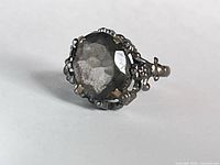 Oblique view of ring showing stone face and filigree setting