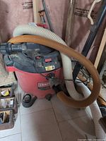 Overall view of Craftsman red canister shop vac with hoses attached