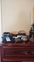Overall view of eyewear, cases, pouches and holster on dresser