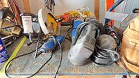All four corded tools on workbench: circular saw, router, random orbit sander, Power Fist rotary tool