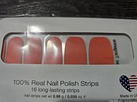 Front close-up showing orange nail polish strips and quantity info