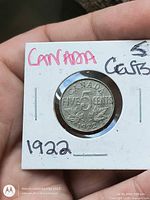 Reverse of 1922 Canada five cents coin in holder