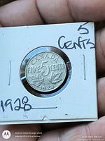 Reverse of 1928 Canada 5-cent coin showing denomination and date