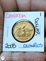 Obverse of 2008 Canada Olympic dollar in holder