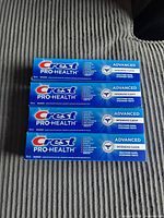 Four Crest Pro-Health Advanced toothpaste boxes front view