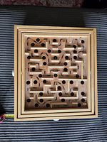 Top view of wooden labyrinth maze showing full maze layout and holes