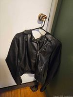 Jacket hanging on door showing front view