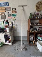 Full view of adjustable safety bar leaning against wall